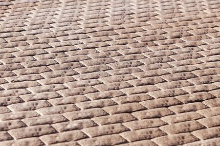 Brown paving from paving stones. Selective focus. Perspective View.の写真素材
