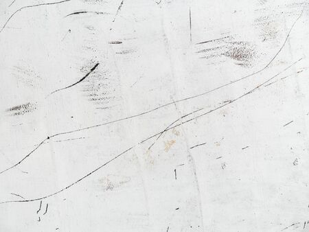 White texture with red scratches. Oil paint, black scratches. The old wall.の写真素材