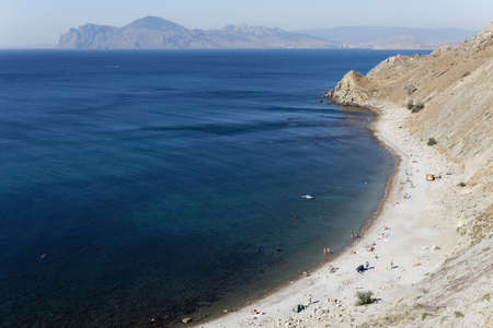 CRIMEA, ORDZHONIKITZE August 19, 2015: Wild beach Ordzhonikidze. People relax on the beach.のeditorial素材
