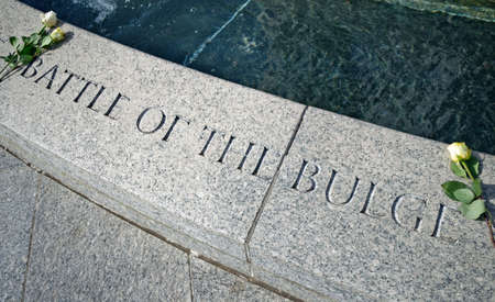 Washington, D.C., USA - November 11, 2017: Two roses are laid down next to the inscription Battle of the Bulge, dedicated to the Ardennes Counteroffensive, on the World War II Memorial located on the National Mall.のeditorial素材