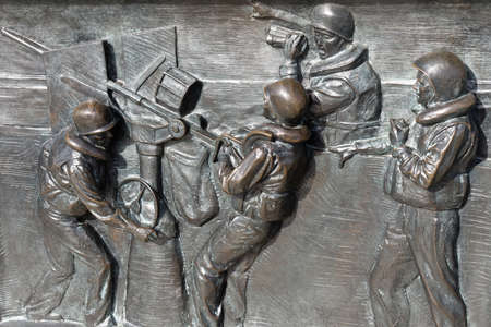 Washington, D.C., USA - November 11, 2017: Bronze bas-relief, showing soldiers firing anti aircraft gun during the Battle of the Atlantic, on the World War II Memorial located on the National Mall.のeditorial素材