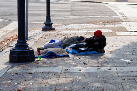 Washington, D.C., USA - November 13, 2017: Two homeless African Americans are lying on the street in downtown Washington, D.C.のeditorial素材