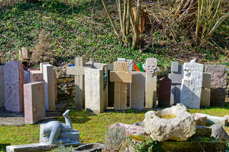 Bern, Switzerland - March 28, 2020: Various gravestones, cemetery sculptures and memorial statues are displayed near a stone-carving studio.のeditorial素材