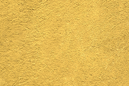 A wall with a rough surface is painted in lemon colorの写真素材
