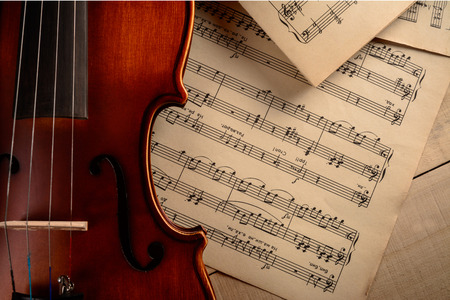sheets with notes lie along with a violinの写真素材