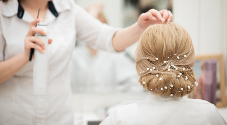 Hairdresser finishing bride's hairsyleの写真素材
