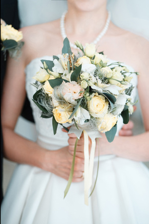 Bride with a beautiful tender wedding bouquetの写真素材