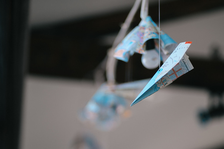 Paper plane and a lightbulb as indoors restaurant decorationの写真素材