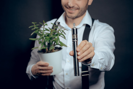 Caucasian man in white shirt vaping