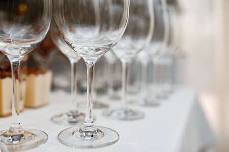 Close up picture of empty glasses on the beige tablecloth  in restaurantの写真素材