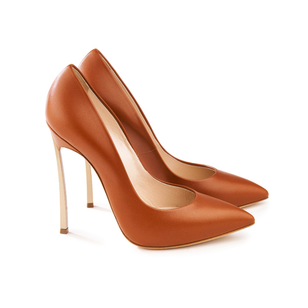 Studio shot of a pair of a brown high-heeled female shoesの写真素材
