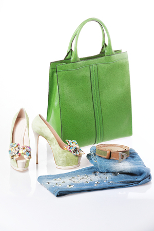 Jeans, green sandals and green leather handbag isolatedの写真素材