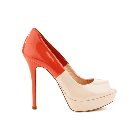Studio shot of a high-heeled lackered female shoe isolatedの写真素材