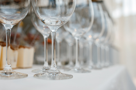 Close up picture of empty glasses on the beige tablecloth  in restaurantの写真素材