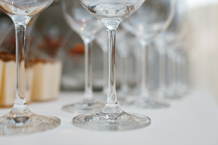 Close up picture of empty glasses on the beige tablecloth  in restaurantの写真素材
