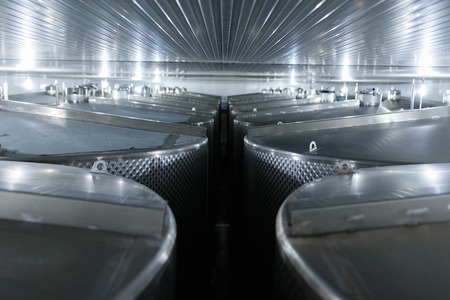 Wine factory tanks under a stainless steel seilingの写真素材