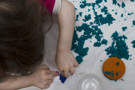 Children's hands molded from colored sandの写真素材