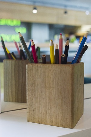 Wooden color pencils holder with reflection in the mirrorの写真素材