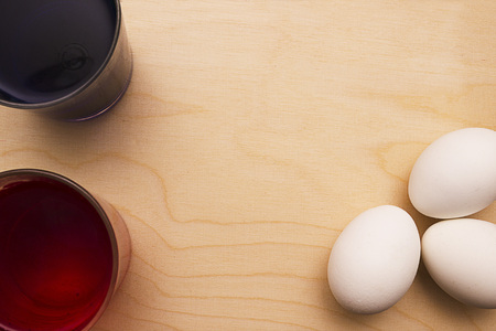 Food coloring and eggs on a wooden background. Dyeing Easter eggs.