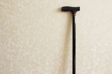 Black metal walking stick on the background of the wall.の写真素材