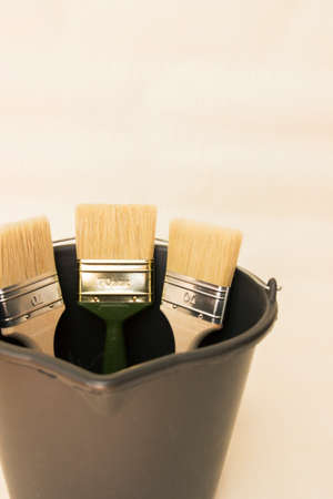 Construction tool for working with wallpaper. Wide brushes in a bucket.の写真素材
