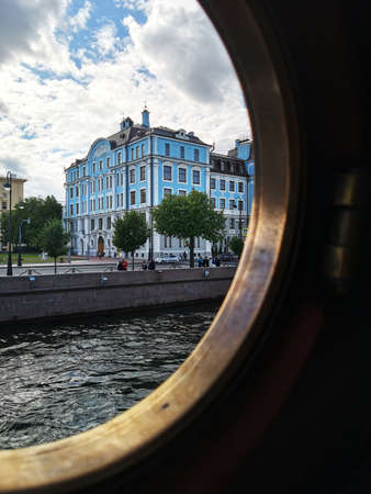 Russia, St. Petersburg - August 2020. The building of the Nakhimov Naval School through the porthole of the cruiser Aurora.のeditorial素材