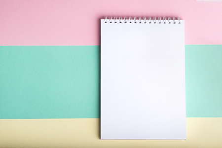 Blank notepad on pastel multicolor background