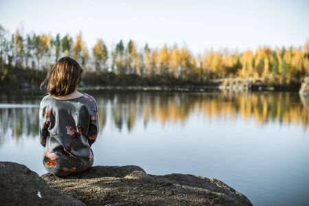 girl sitting by the river
