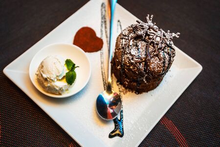 Cake, ice cream, chocolate. Chocolate Fudgy Brownie with Vanilla Ice Cream and Chocolate Syrup on...