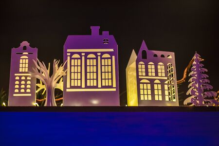 Paper Town. Papercraft House And Papercraft Building. Architecture business concept. Real estate and property concept. Beautiful winter landscape with small houses made of paper illuminated inside.の写真素材