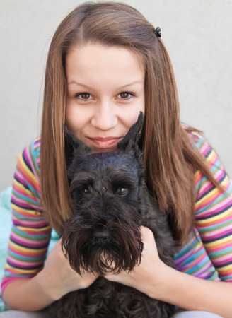  pretty young girl with her cute miniature schnauzerの写真素材