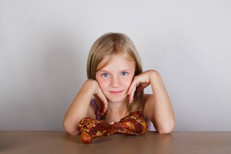 carnivore keto diet concept - little blond girl  eating raw meat. Health food.の写真素材