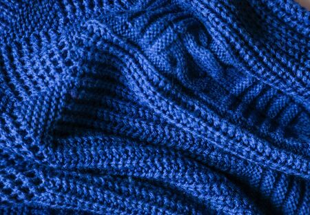 Classic blue dark knitted background. Close up texture . wrinkled and shadows, top view. 2020 trend color.の写真素材