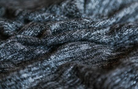 Grey cotton fabric background. Close up gray fabric texture background. wrinkled and shadows,...