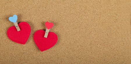 Greeting Card banner for Valentine's Day. Red hearts with clothespins, on wooden background. Copy space. Flat lay. Top view.の写真素材