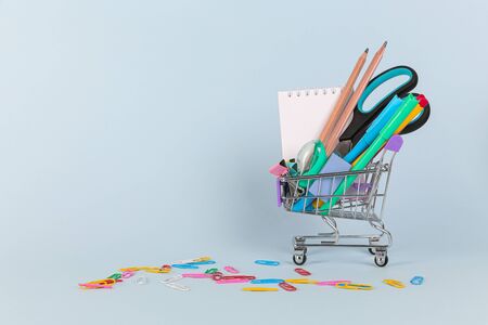 Back to school shopping concept. School supplies on blue background. Flat lay, top view, copy space.の写真素材