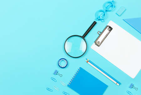 Back to school shopping concept. School supplies on blue background. Flat lay, top view, copy space.の写真素材
