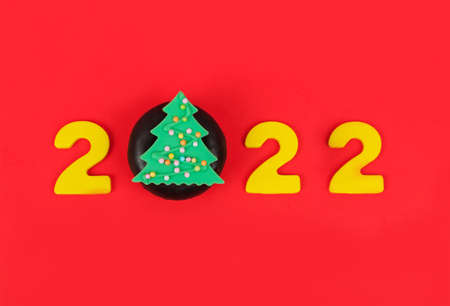 2022 creativity inspiration Happy New Year concepts with a sweet baking donut on red background.の写真素材