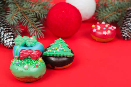 Set of different Christmas cookies donats and cakesicles on red background. Christmas decorations.