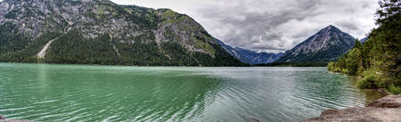 Ultra wide panorama of the Plansee in Austria in the middle of the alps. Providing a wide view and a great feeling for the size of the lake.の写真素材