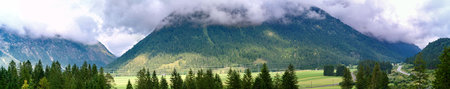 Mountain panorama in the Austrian alps. With dark clouds on the top of the mountain.の写真素材
