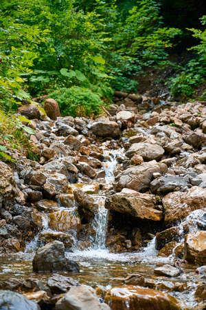 Clear, clean water flowing down a mountain stream through rocks in the Austrian Alps.の写真素材