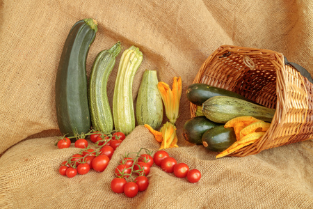 Zucchini and cherry tomatoes  harvest scene on jute. Vegetable still life compositionの写真素材