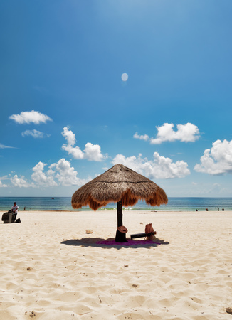 Palm-leaf umbrella parasol on the Caribbean beach, Playa Delfines, Cancun, Mexico, September 7, 2018のeditorial素材