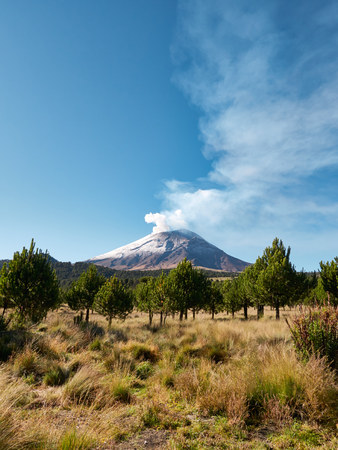 Smoke comes out from the Popocatepetl volcano seen from Itza-Popo National Park, Mexicoの写真素材