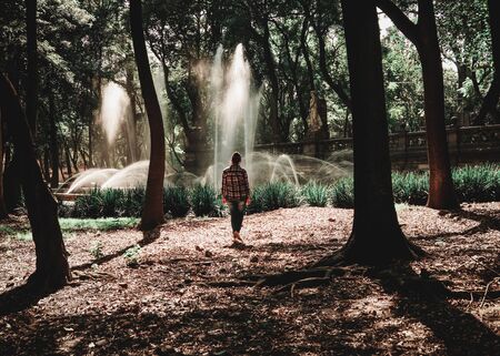 Fountain in the park of Bosque de Chapultepec with young womanの写真素材