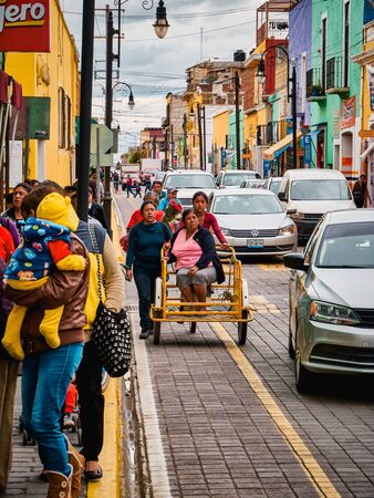 Mexican young women push a tricycle with an elderly womanのeditorial素材