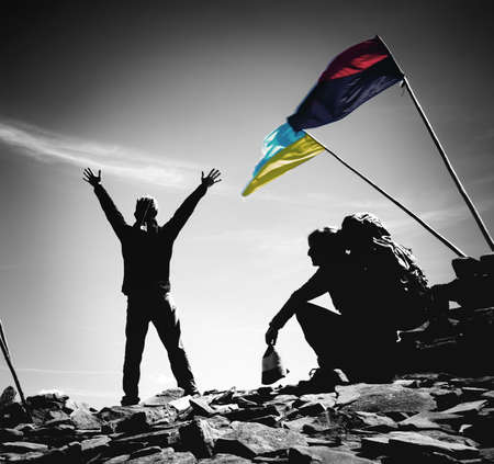 Silhouettes of people in the Ukrainian mountains and national symbolsの写真素材