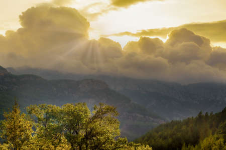 The first rays of sun because of clouds in mountains of Turkey
