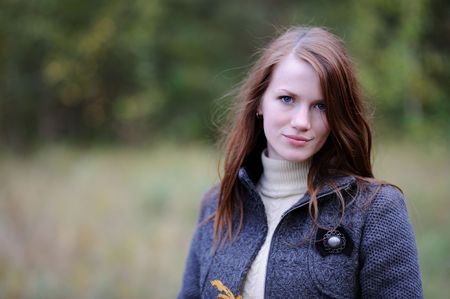 Beautiful young elegant woman in autumn forestの写真素材